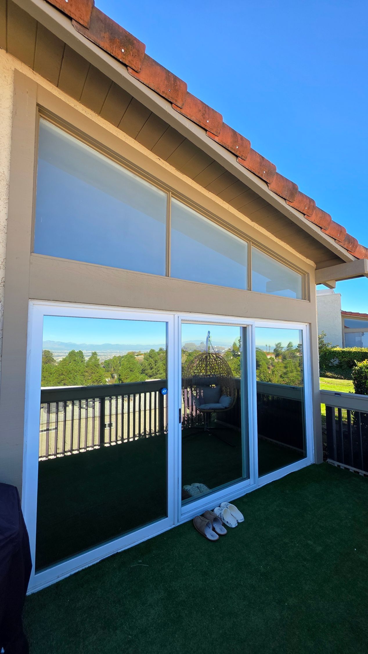 A window with a lot of windows and trees behind it.