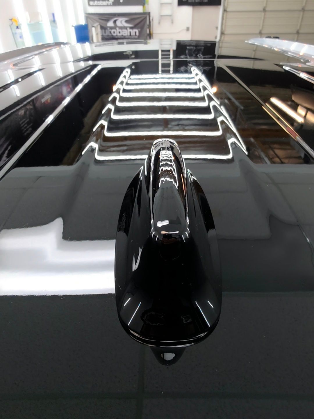 A black car with a antenna on top of it