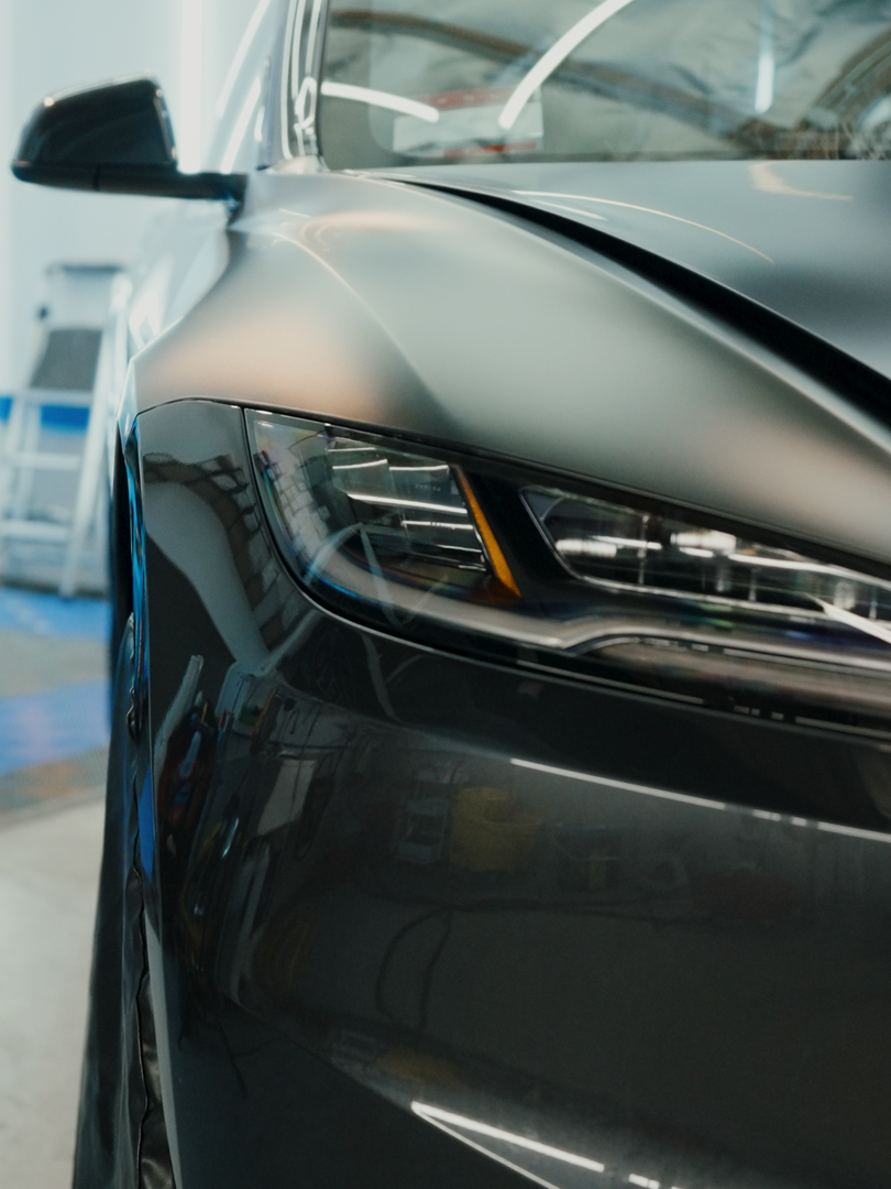 A close up of the front of a black car