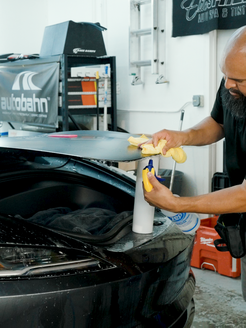 A man is working on a car in a garage.