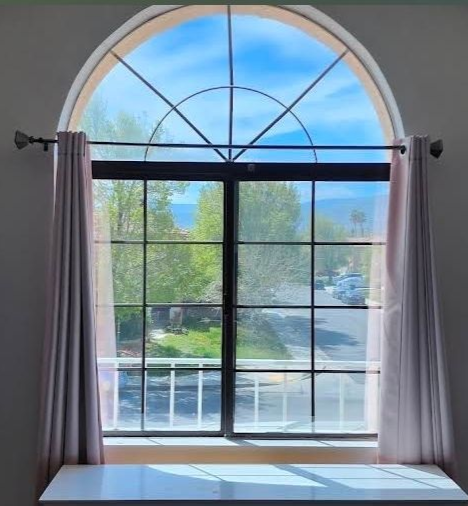 A white window with a blue sky reflected in it