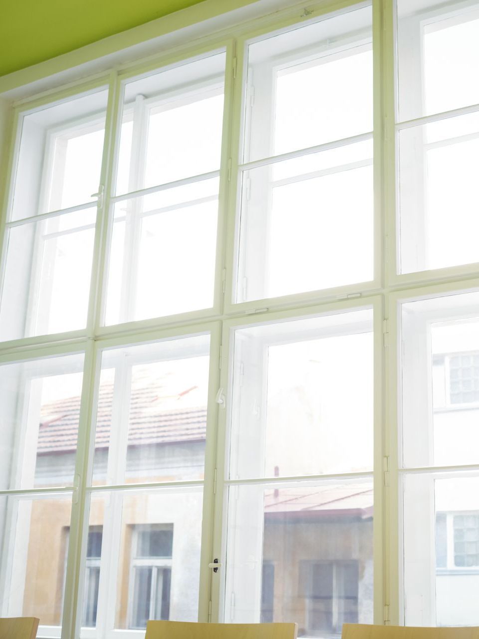 A room with a lot of windows and a green ceiling.