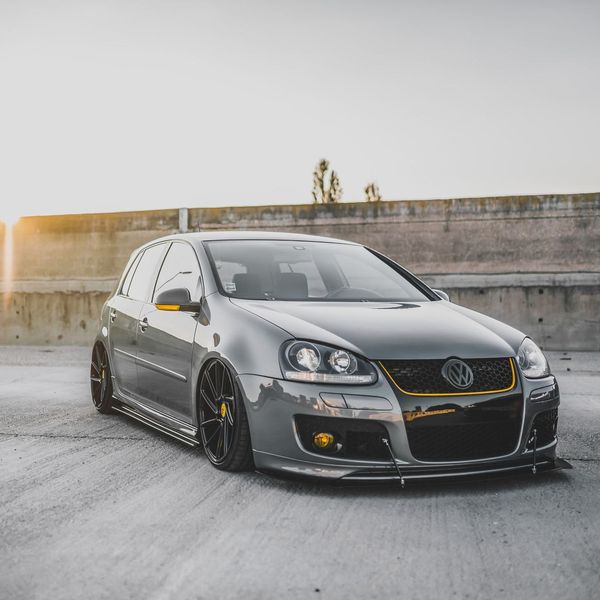 A volkswagen golf is parked on the side of the road