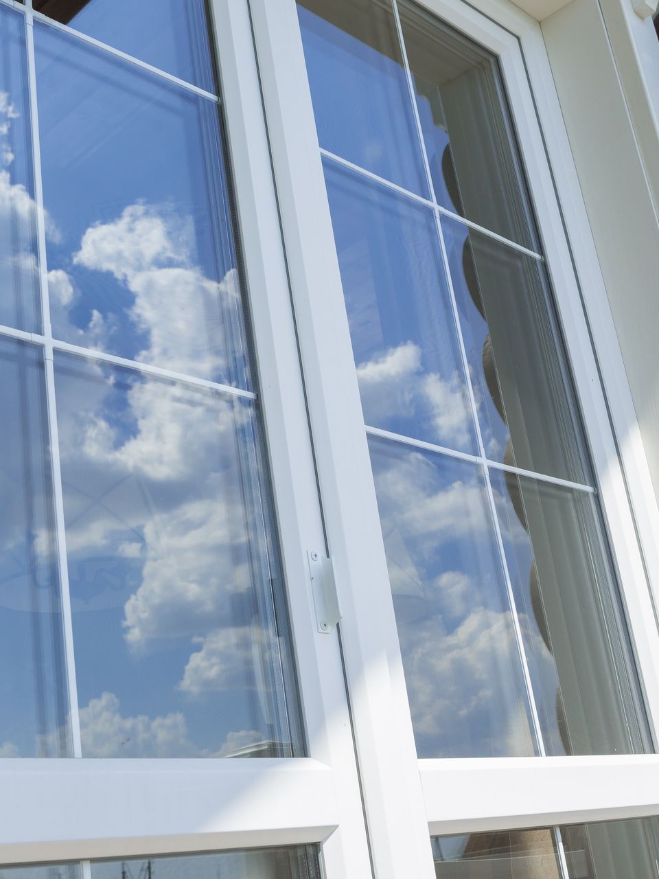 A white window with a blue sky reflected in it