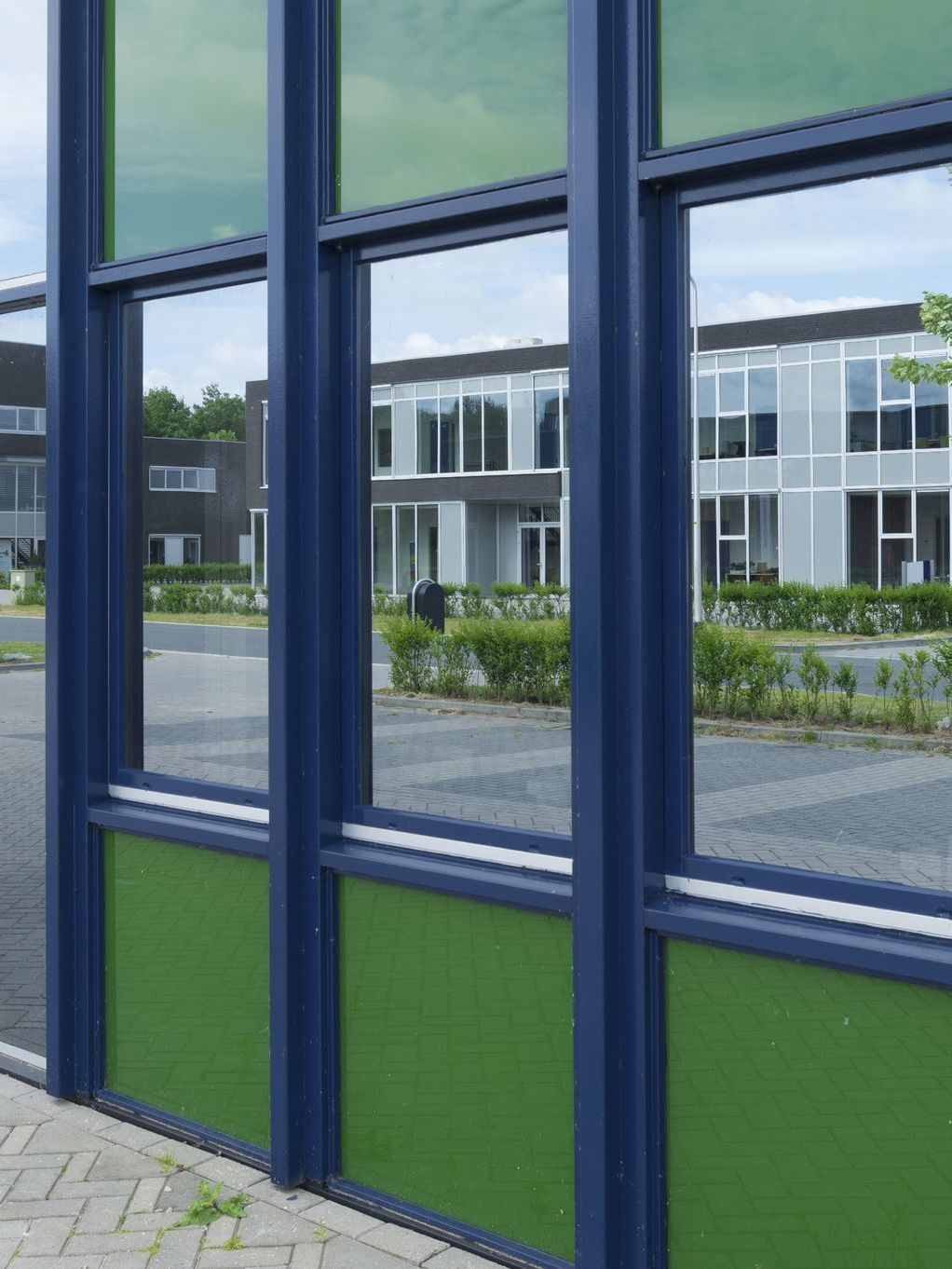 A blue and green building with a lot of windows
