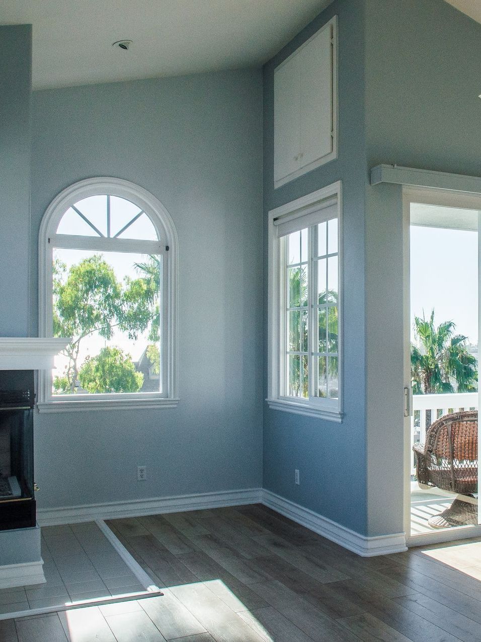 A living room with a fireplace and a large window