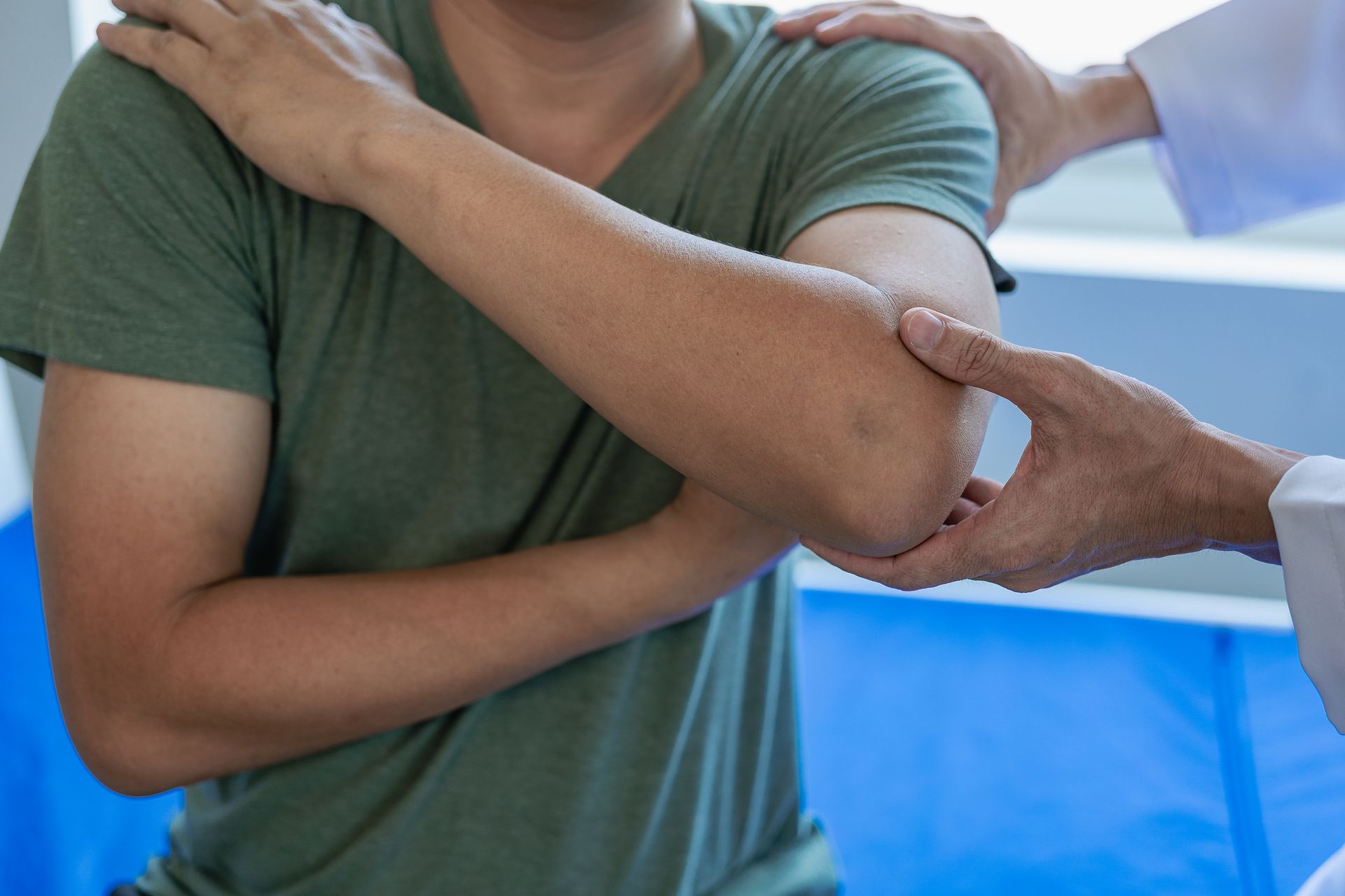 Person receiving instrument-assisted soft tissue mobilization on their lower back.