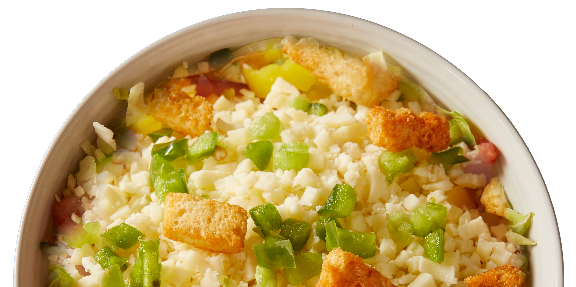 A close up of a salad in a bowl on a white background.