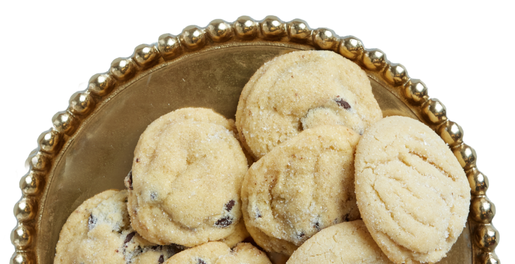 A gold plate topped with chocolate chip cookies on a white background.