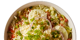 A close up of a salad in a bowl on a white background.