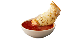 A piece of bread sticking out of a bowl of sauce