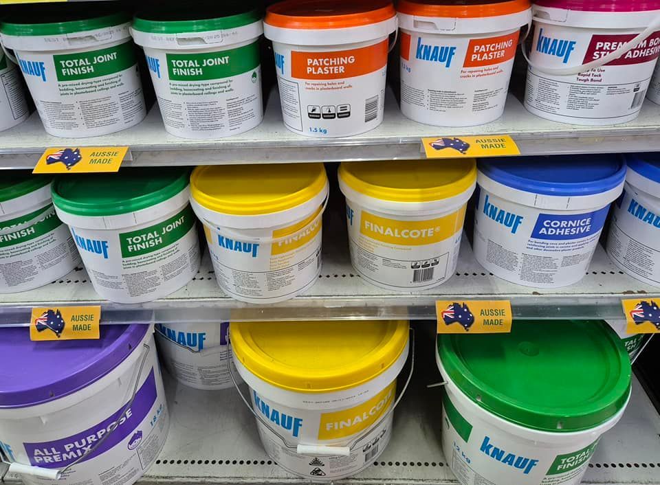 A shelf filled with buckets of knauf paint. — Beerwah Co-Op in Beerwah, QLD