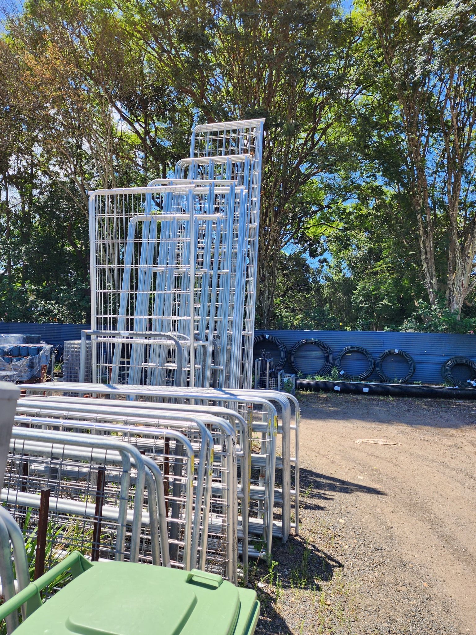 A bunch of metal fences are stacked on top of each other in a parking lot. — Beerwah Co-Op in Beerwah, QLD