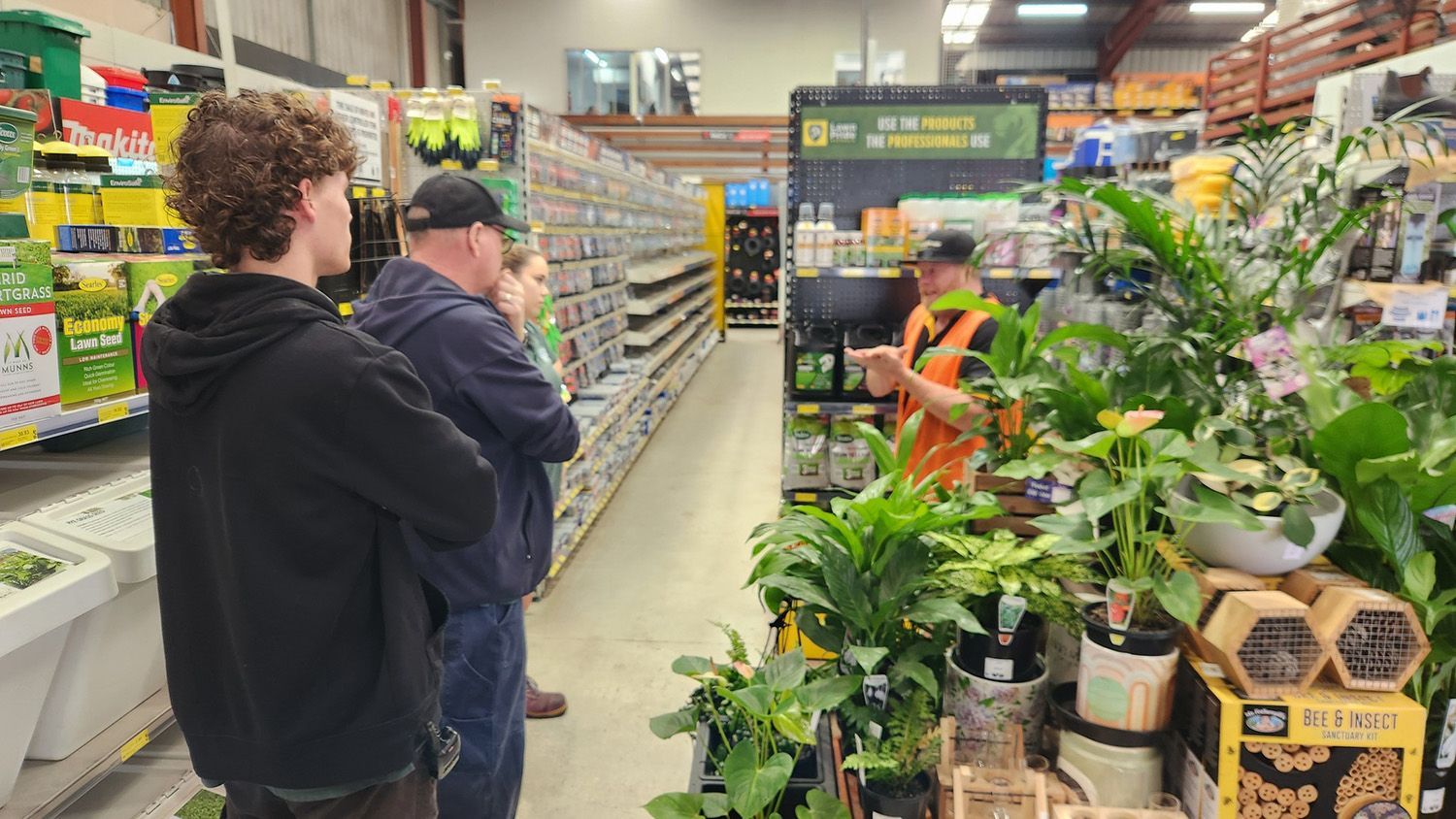 Customers Browsing Rural Supplies In Store Aisle