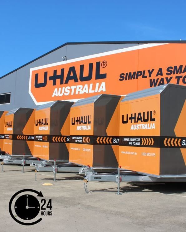 Orange U-Haul Trailers lined up for Hire — Beerwah Co-Op in Beerwah, QLD