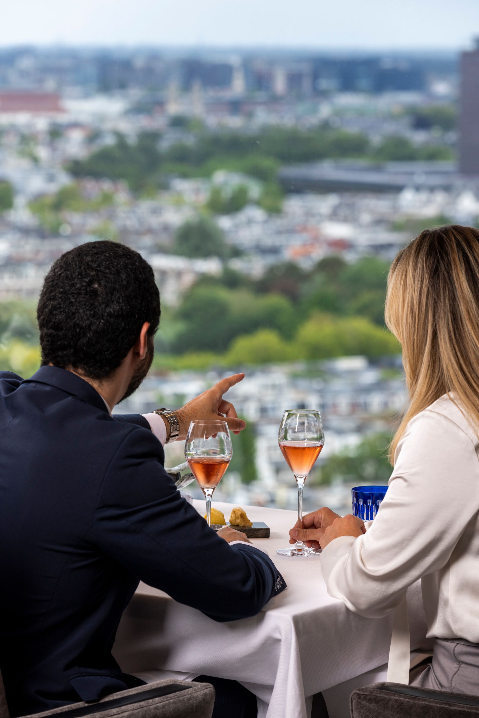 A telescope is sitting on a tripod overlooking a city.
