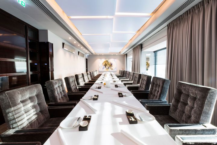 A long table and chairs in a conference room