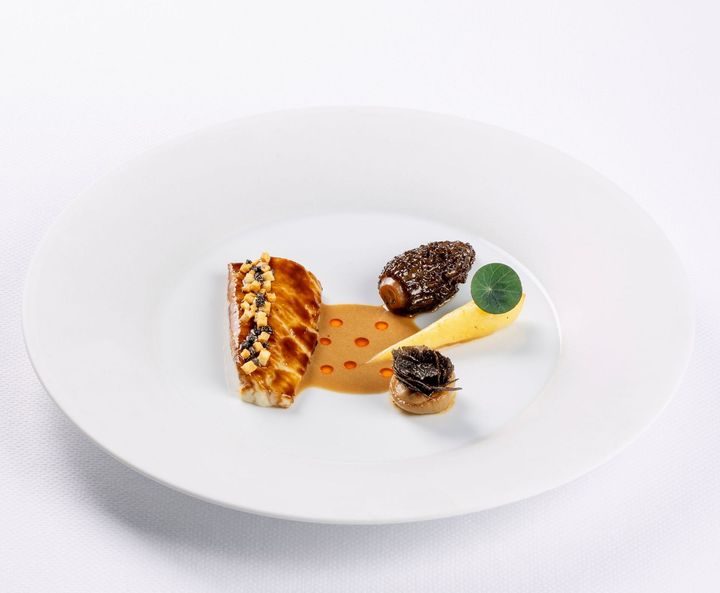 A white plate topped with a variety of food on a table.