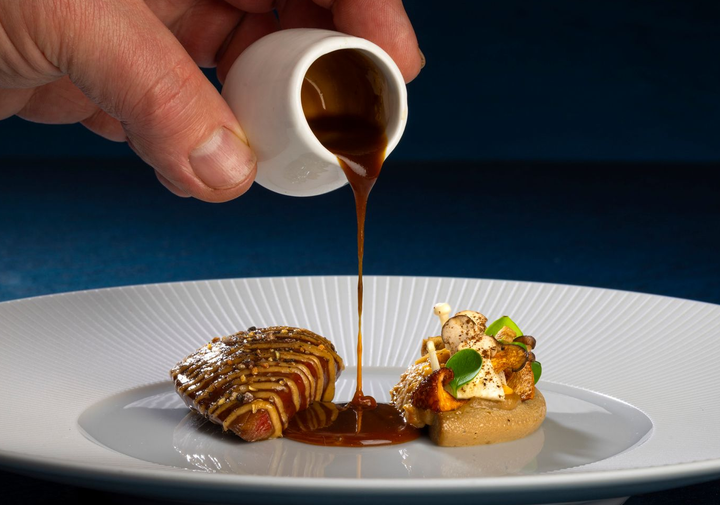 A plate of food with a spoon sticking out of it