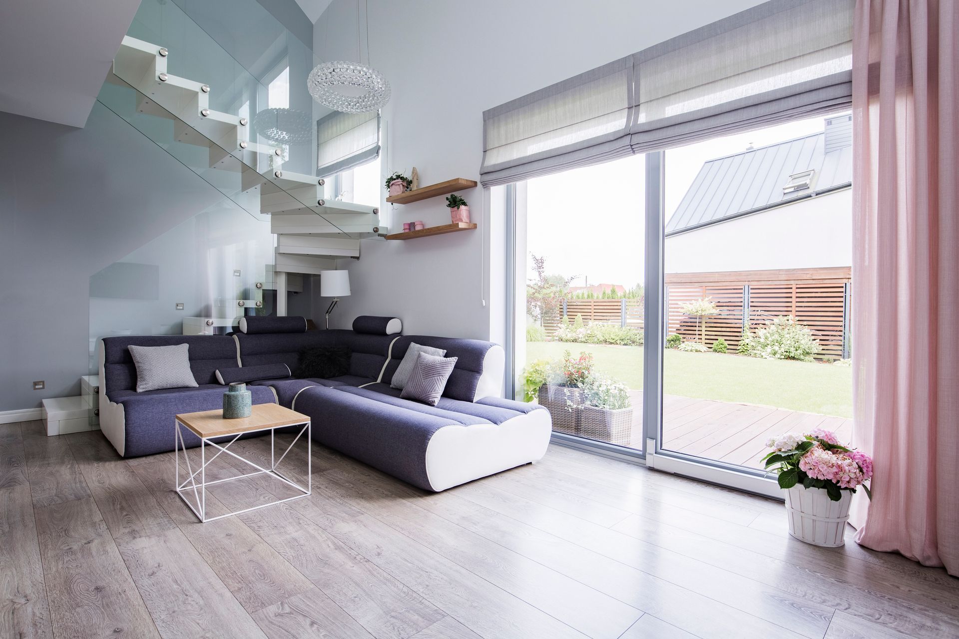 A living room with a couch , coffee table , and stairs.