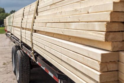 A truck is carrying a stack of wood.