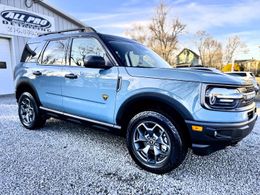 A man is holding a piece of glass with a picture of a cat on it
