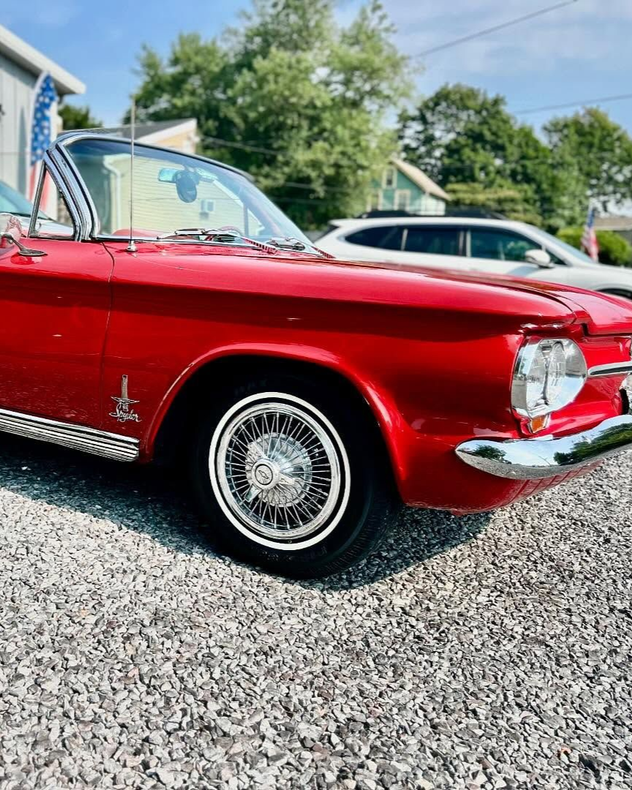 A person is applying a clear film to the hood of a car.