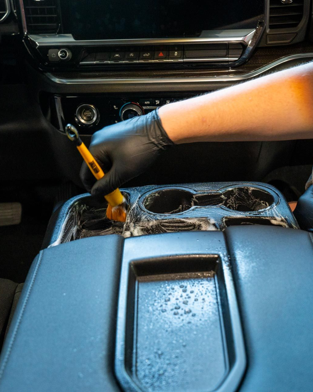 A close up of water drops on the hood of a car