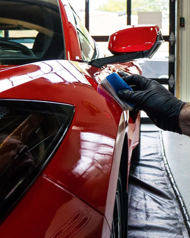 A close up of water drops on the hood of a car