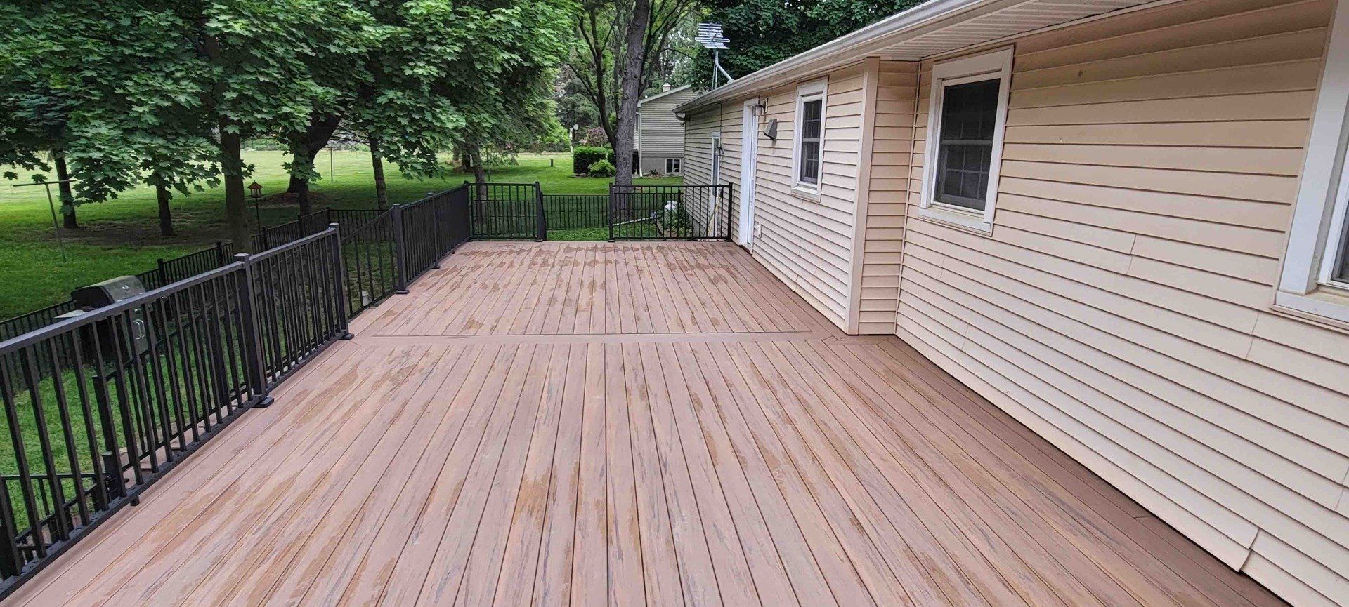 there is a large wooden deck in front of a house .