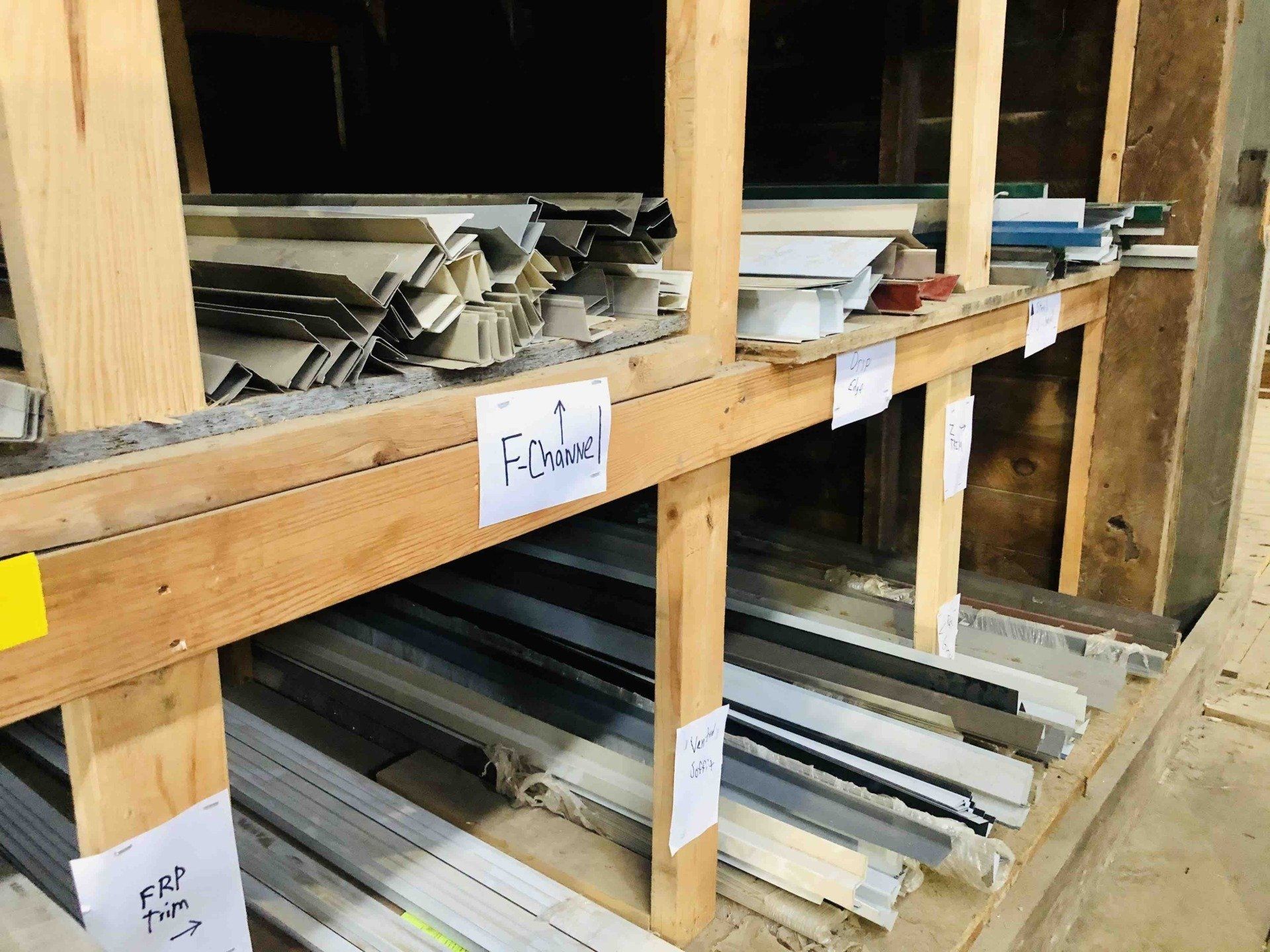 a wooden shelf filled with a variety of metal pieces and a sign that says finder