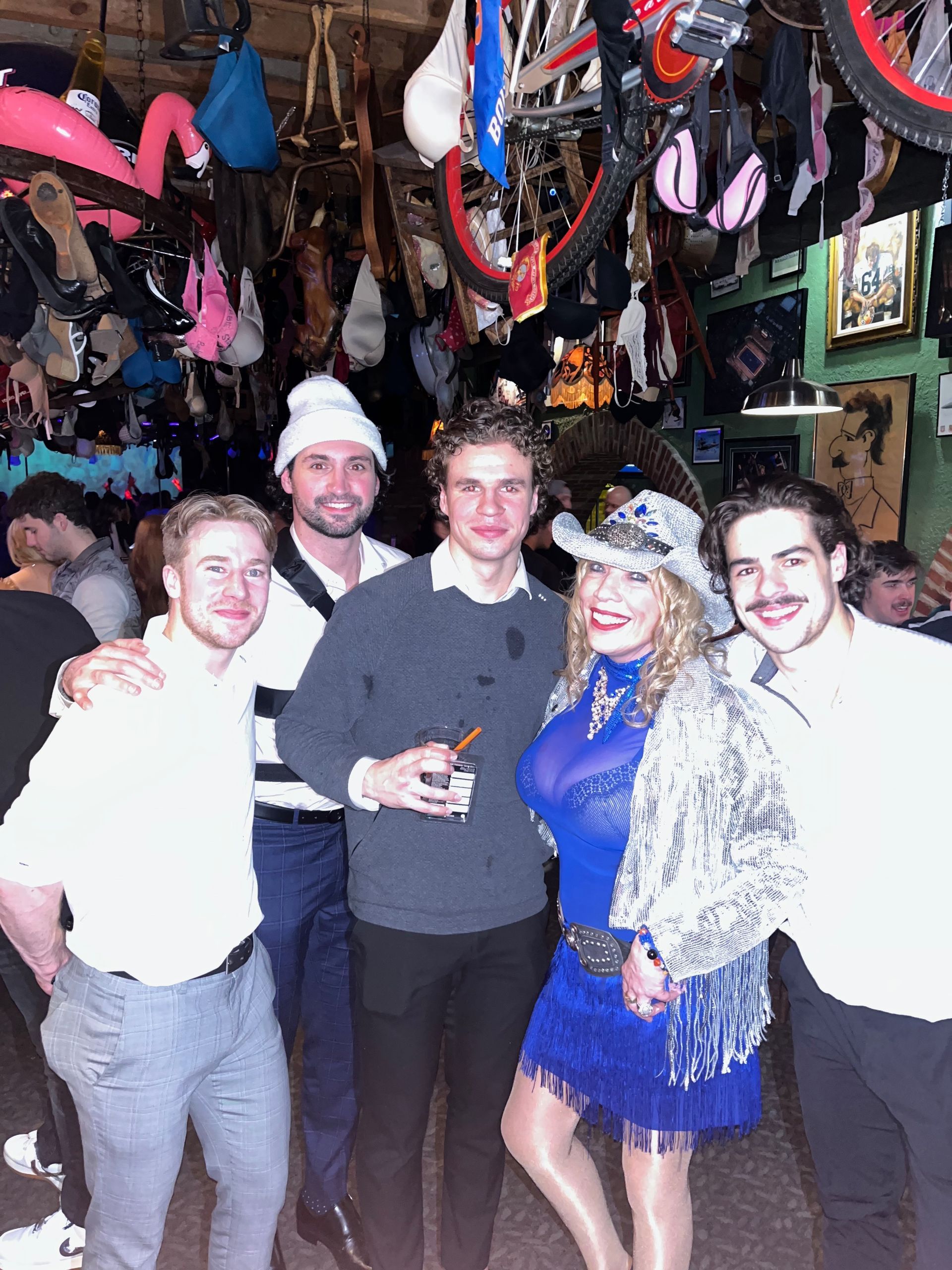 A group of people posing for a picture in a bar