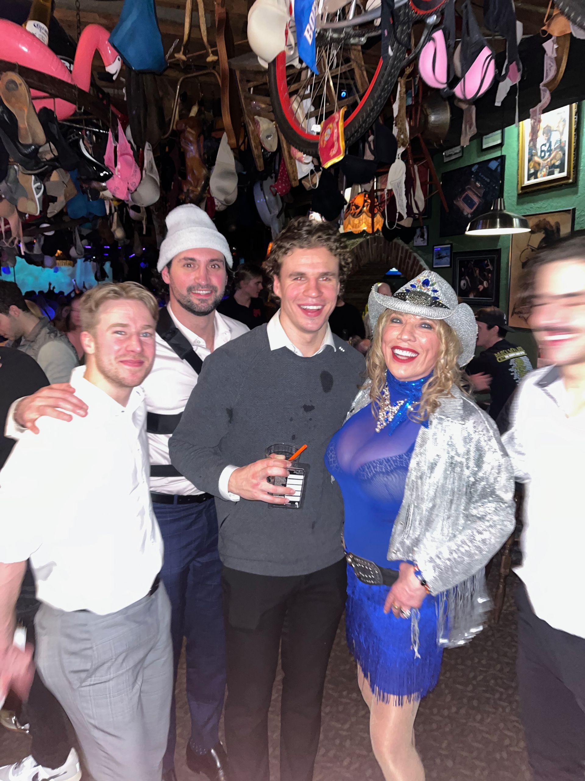 A group of people posing for a picture in a bar
