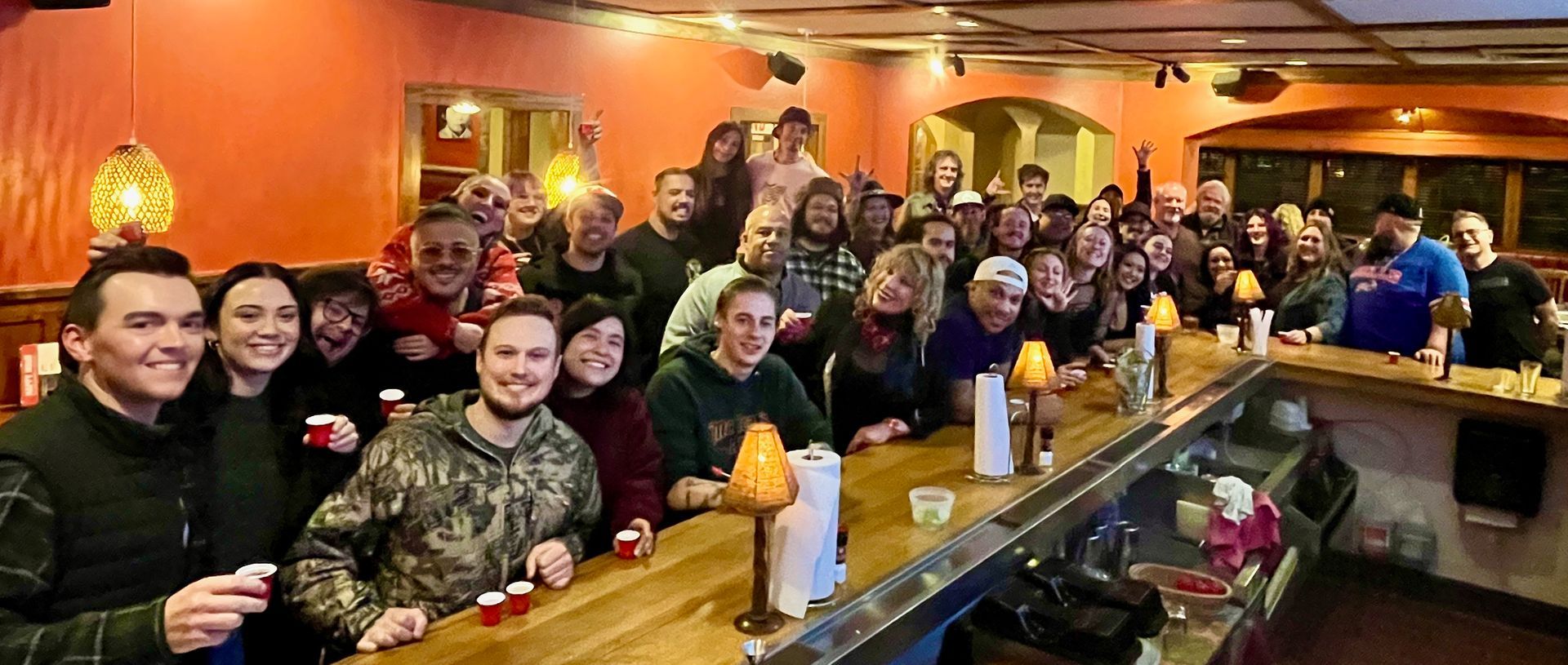 A group of people are sitting around a table in a restaurant.