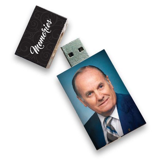 Black USB flash drive with a portrait photo on the case and a separate cap labeled “Memories”