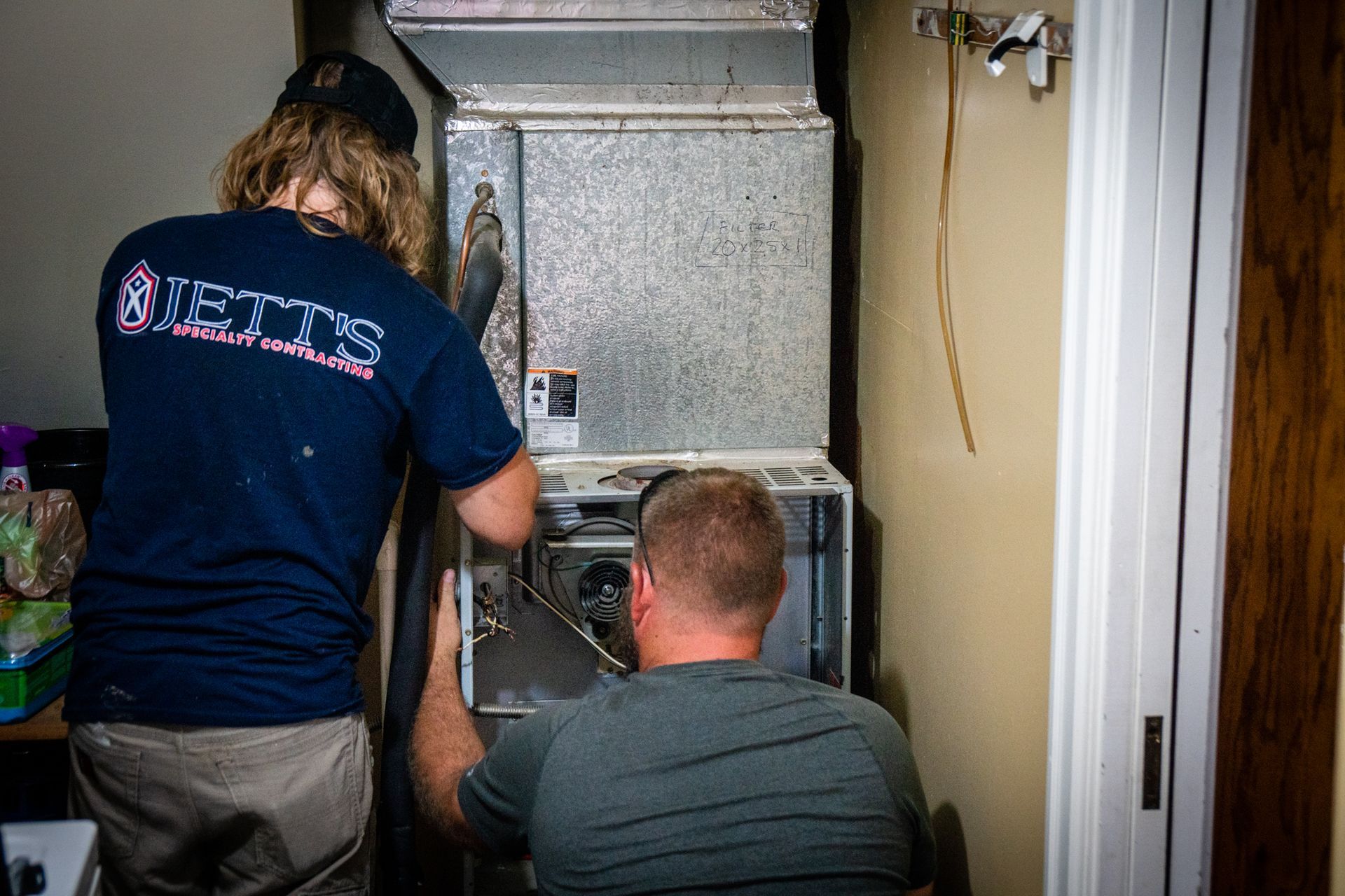 Jetts HVAC Techs Changing Out Air Filter