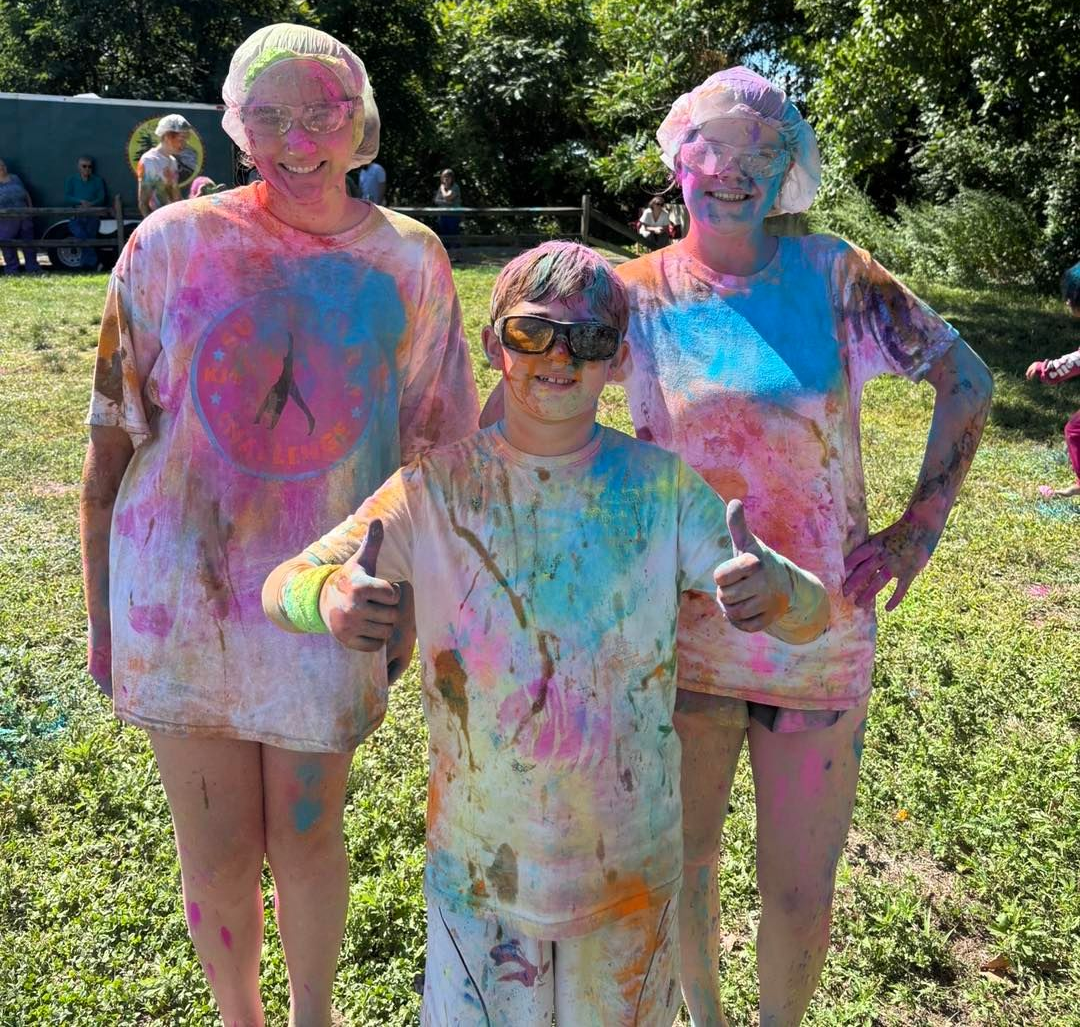 Boy covered in colorful powder during a Holi festival.