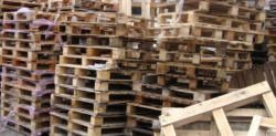 A pile of wooden pallets stacked on top of each other.