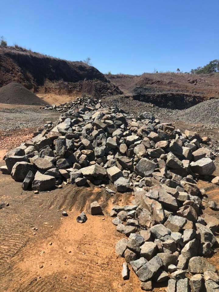 Pile of Gray Rocks in a Quarry, With Dirt and Hills — The Caves Quarry CQ in The Caves, QLD