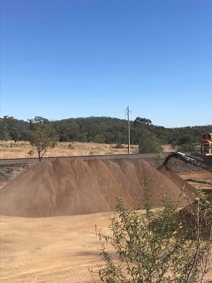 Pile of Brown Dirt Next to Railroad Tracks — The Caves Quarry CQ in The Caves, QLD
