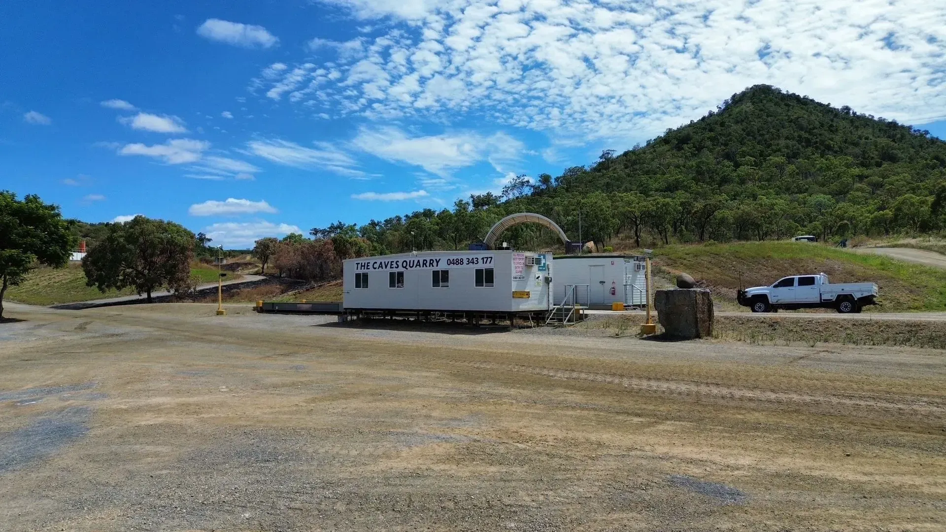Construction Site With Trailers, White Truck, and Mountain Under a Blue Sky — The Caves Quarry CQ in The Caves, QLD