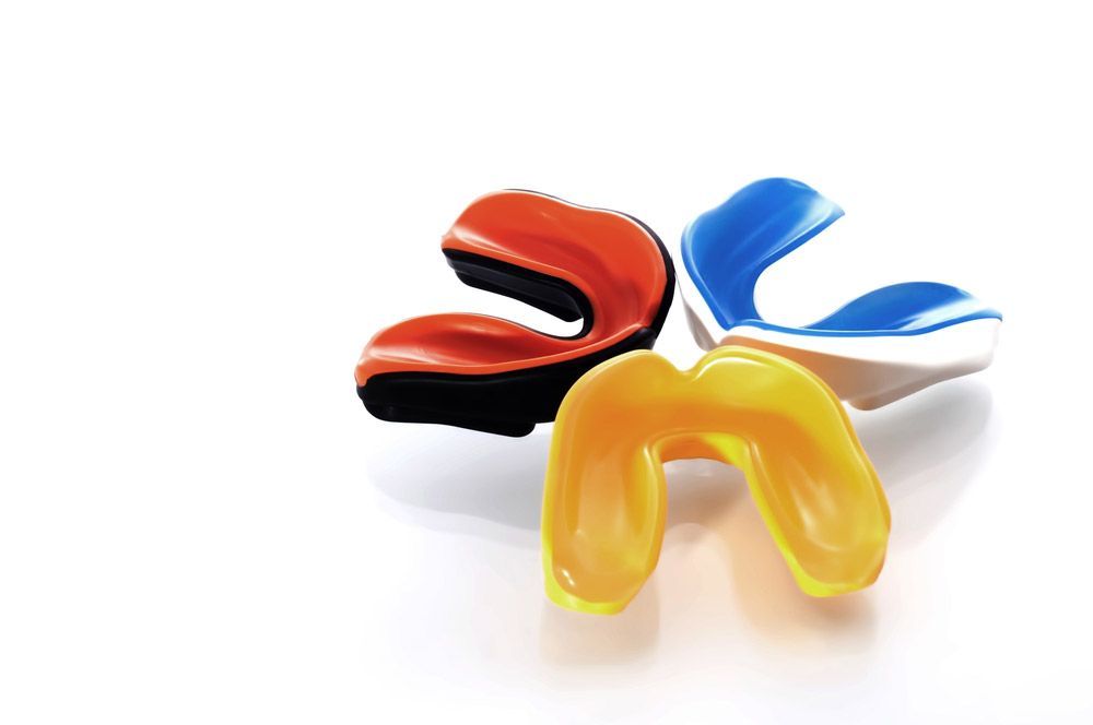 Mouthguards With Different Designs On White Background — Custom Mouthguards in Gosford, NSW