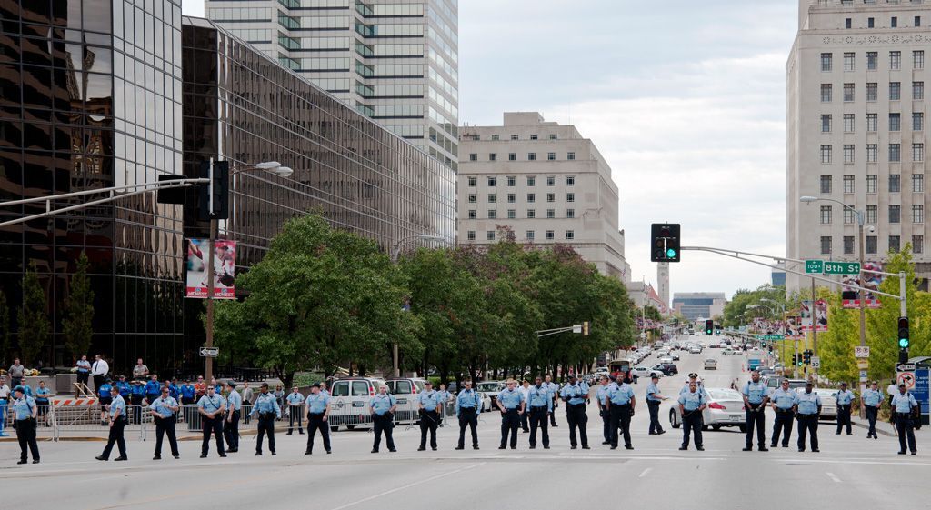 In 2011, the St. Louis Metropolitan Police Department was less tolerant of First Amendment assembly and free speech than they are today. The tendency then was to confront, escalate and arrest protesters. Seen here, the police line sought to contain the Occupy STL march by limiting it to a few blocks. This type of aggressive policing, which ignored Constitutional Rights, often led to fatal state violence (FSV), highlighted elsewhere in this gallery. Photographed October 18, 2011. 