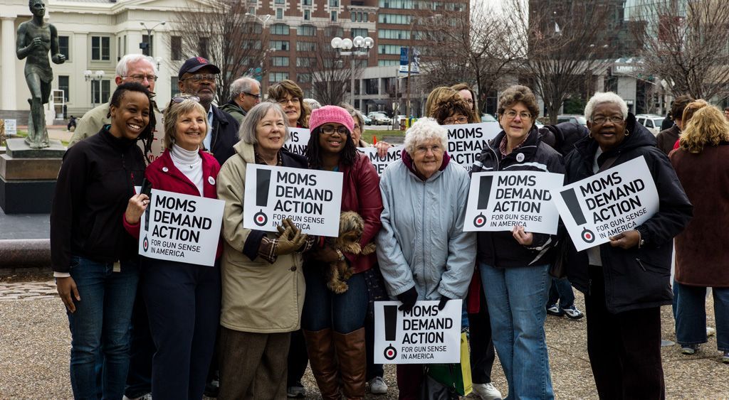 This group of moms and dads had come to the protest together and shared their stories of local gun violence, particularly about drive-by shootings and the increase in youth deaths by other youths. Photographed March 30, 2013.