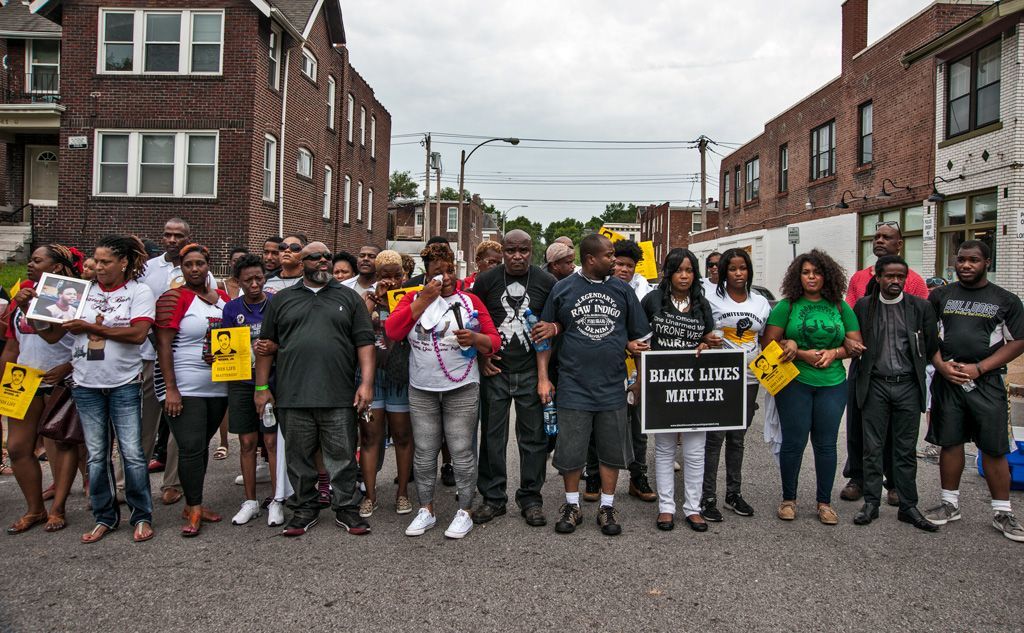 The killing of Black men, young and old, continued after Michael Brown’s death like a plague. Here, prior to a candlelight vigil, family, friends and neighbors of 18-year old VonDerrit Myers, Jr., gathered in the Shaw neighborhood where he was gunned down by an off-duty St. Louis police officer pulling a secondary security guard job. The off-duty officer chased the 18-year old ultimately firing 17 shots at him before he was killed. The officer was not in uniform and did not identify himself as an officer, but began pursuing VonDerrit and two friends with his weapon already drawn, causing the trio to run. Photographed on August 8, 2015. 