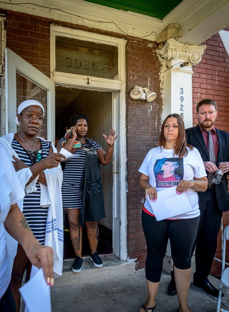 Tenants, lawyers, and social workers stand on the front porch of an apartment where the tenant is being evicted through unlawful procedures by an absentee landlord. The tenants were not notified in advance and caring attorneys were able to arrive to help quickly, along with social workers, neighbors and several affordable housing activists. Photographed on August 4, 2017.