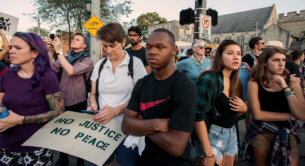 Protesters gather during a march for slain Anthony Lamar Smith, after police officer Jason Stockley had been acquitted of his murder. Stockley, a known rogue officer, was reported to have stored his personal AK-47 assault rifle in the trunk of a police car to use to pursue those he perceived as criminals. This group of protesters marched from the Delmar Loop business district to the corner of Skinker Avenue and the Forest Park Parkway, blocking traffic along the way to call attention to the continued killing of black men in situations where white men are usually only detained or arrested. The look on their faces tell a vivid story. Photographed on September 16, 2017. 
