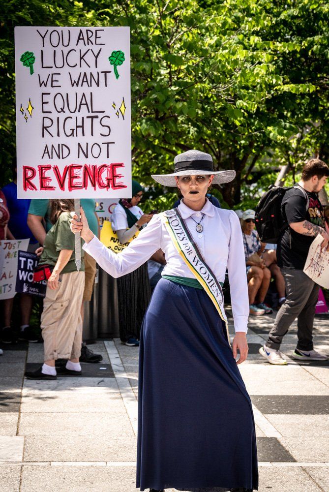 A woman is holding a sign that says `` you are lucky we want equal rights and not revenge ''  at a reproductive rights rally in Kiener Plaza, downtown St. Louis, Missouri in 2022. Women's rights. Civil rights. Human rights. First Amendment rights.