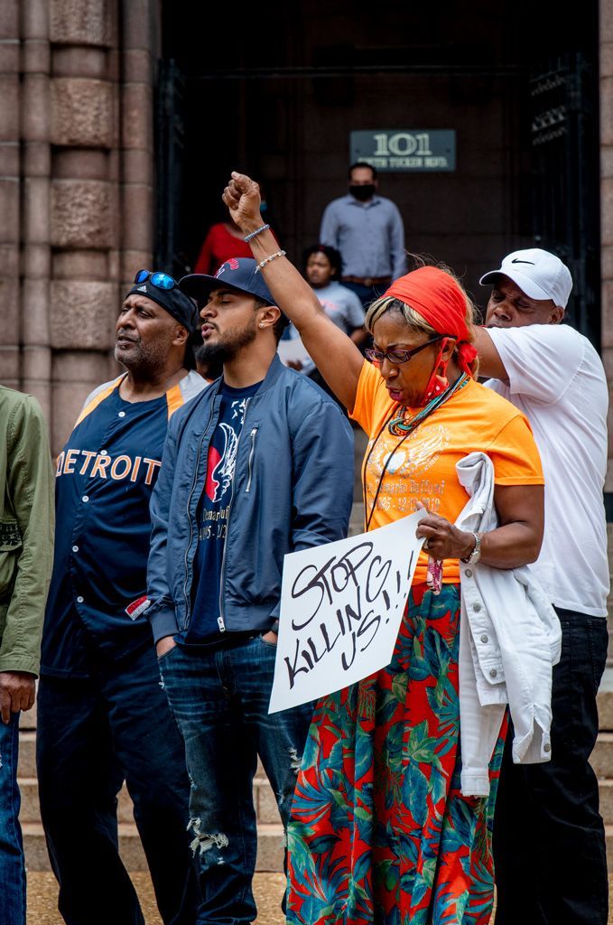 Families of victims of Fatal State Violence (FSV) assembled on the steps of St. Louis City Hall to decry the continued killing of Black men and women by police. It was both a demonstration and a memorial for their deceased loved ones. Here, a mother with husband and son, remember their son and brother in a plea for restraint. Photographed May 24, 2022.