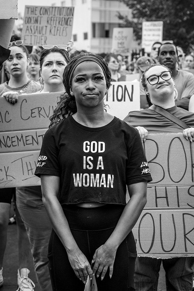 a woman wearing a shirt that says god is a woman, June 24, 2022 protest at St. Louis Planned Parenthood after US Supreme Court struck down Roe v Wade, Award of Excellence in Art St. Louis juried show.